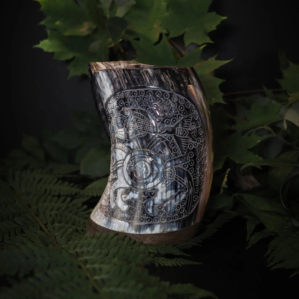 Handsnidad hornmugg med Oden till häst: detaljrik medaljongram med keltiska knutmönster på naturlig horn, omgiven av gröna ormbunkssidor