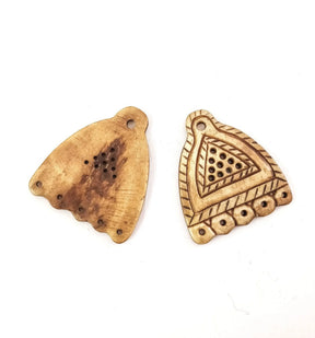 Bone bead spreader shown front and back - plain side with hand-tool marks, decorated side with Viking triangular patterns and five holes
