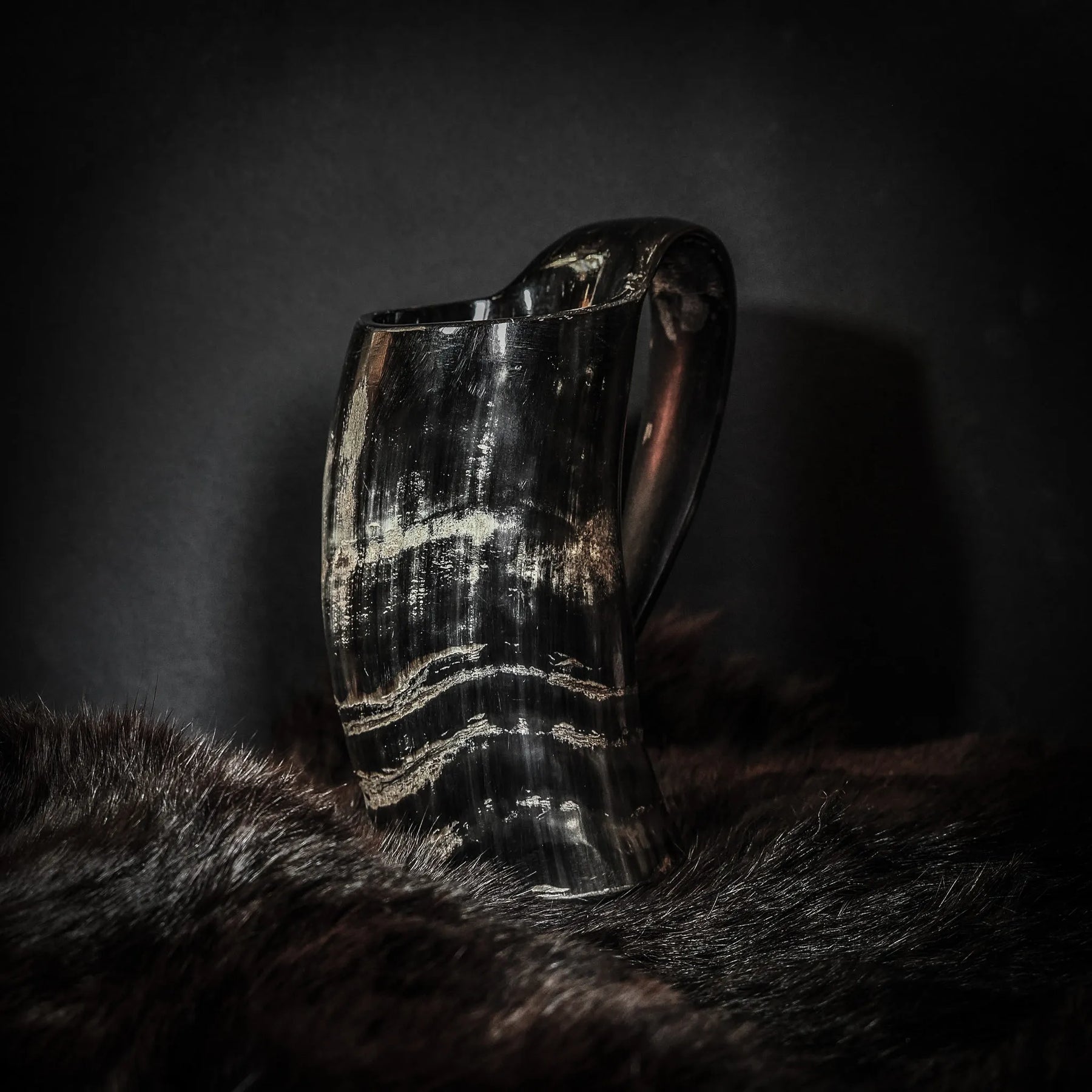 Stor kaffemugg i polerad horn med naturliga fibertextur och elegant ringdesign, fotograferad mot mörk bakgrund