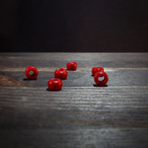 Red glass beads 5mm diameter with 3mm center holes arranged to show color uniformity and smooth finish, suitable for jewelry making