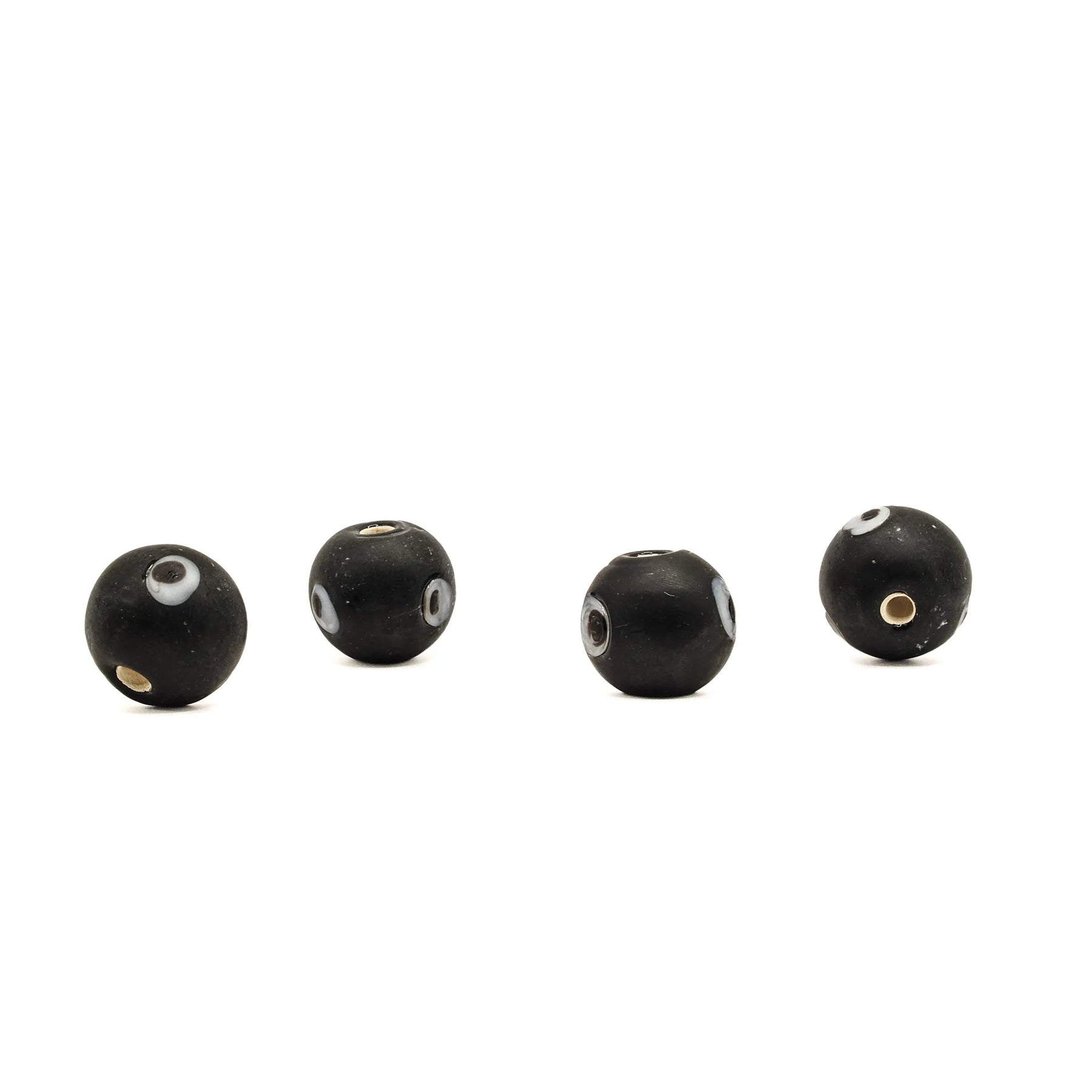 Black glass bead Birka – four beads in a row, eye decoration and holes visible in different positions
