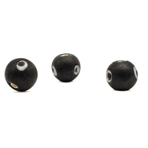 Black glass bead Birka – three beads with eye decoration, one of the holes visible on each bead