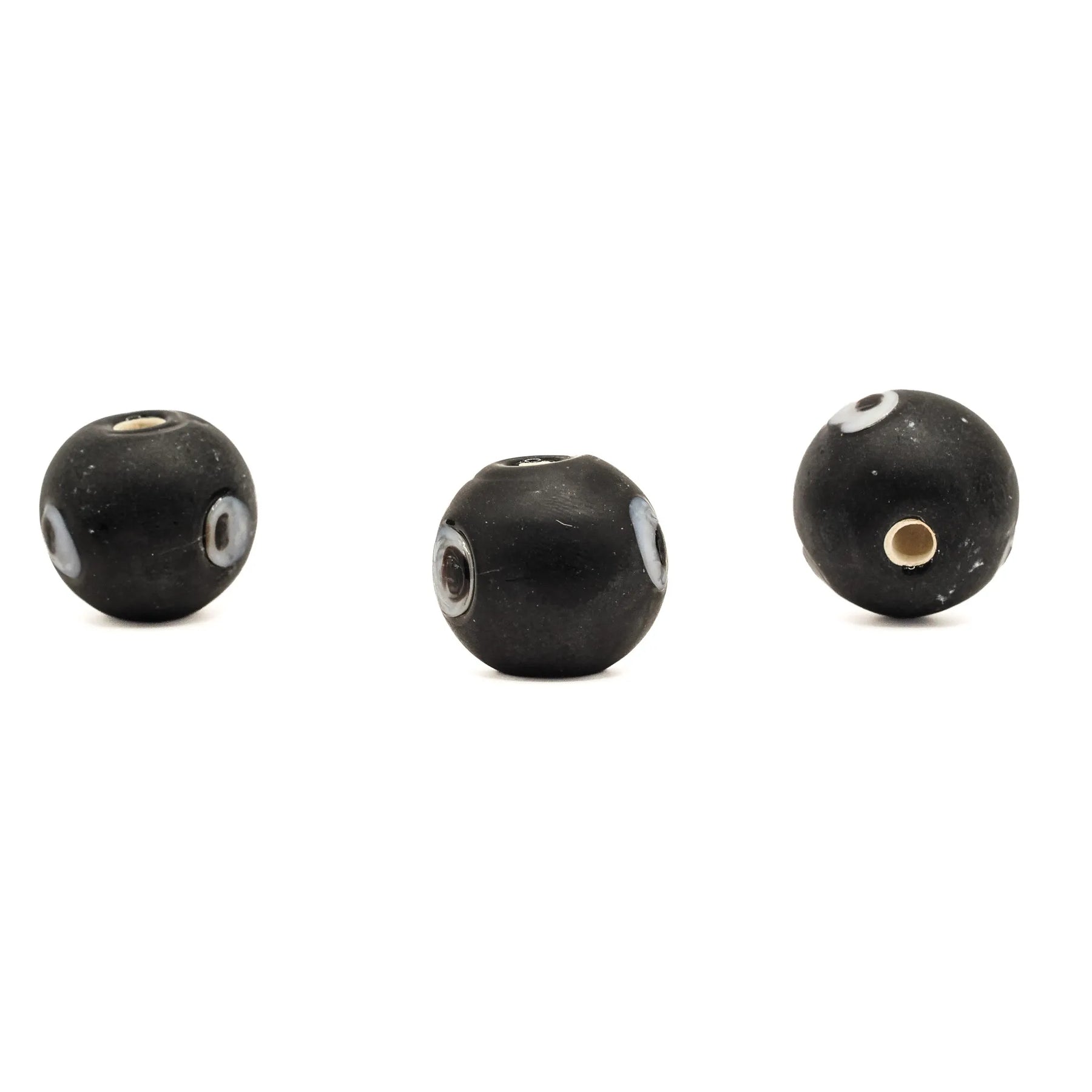 Black glass bead Birka – three beads seen from the side, eye decoration and holes at different angles