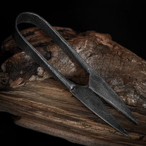 Large herb shears – folded, lying diagonally across driftwood
