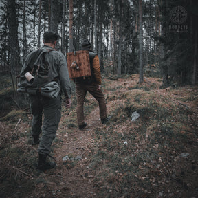 Two people seated outdoors at night using handfelted wool blankets for warmth, demonstrating outdoor camping use