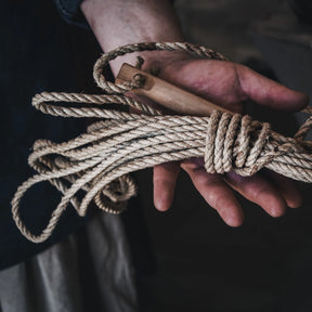 6-meter hemp tent rope (Tältrep i hampa) held in hands showing braided texture, Swedish military-grade camping equipment