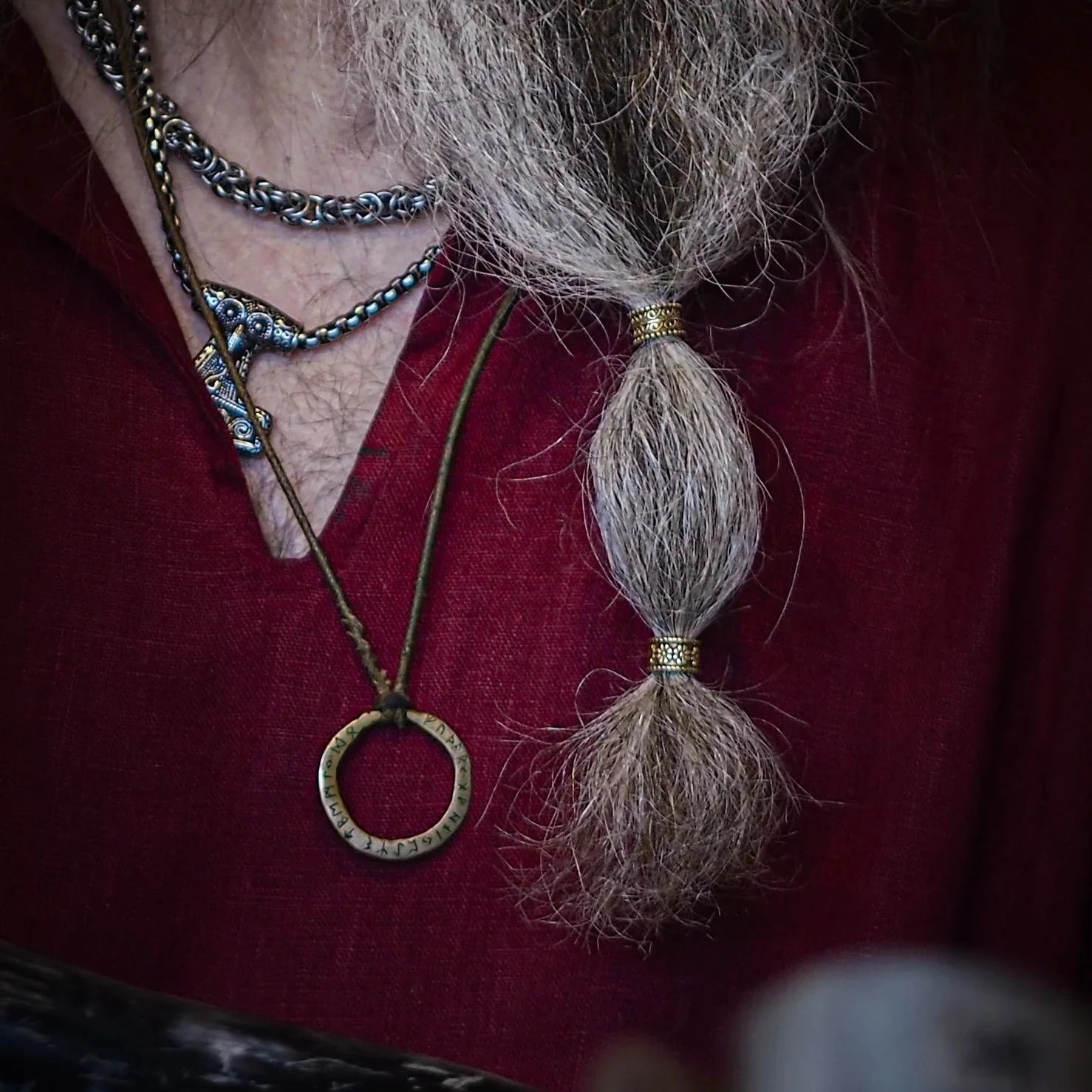 Two beard beads with heart-shaped embossed centers and beaded frame borders in contrasting finishes