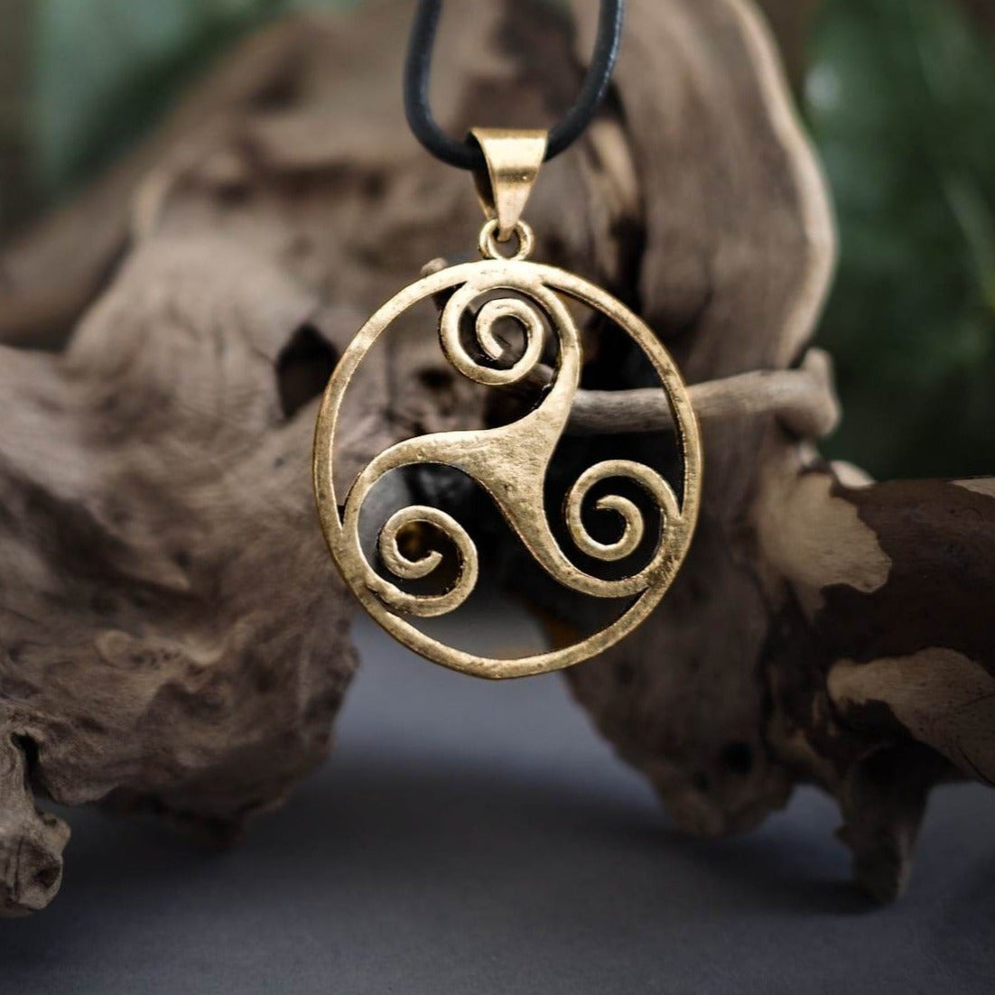 Brass triskele pendant with three spiral horns motif in warm gold tone
