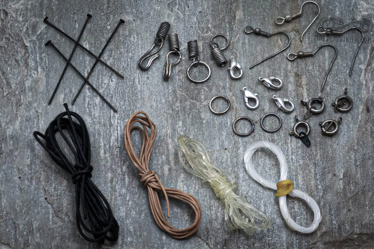 Blue bead assortment box showing six different glass bead varieties and metal jewelry-making supplies