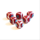 Red glass bead with white and blue-gray decorative pattern, shiny finish, approximately 14-18mm diameter, Viking-era inspired design