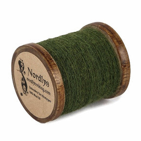 Nordlys-branded embroidery thread of 100% green wool on wooden spool, photographed against white background for e-commerce use