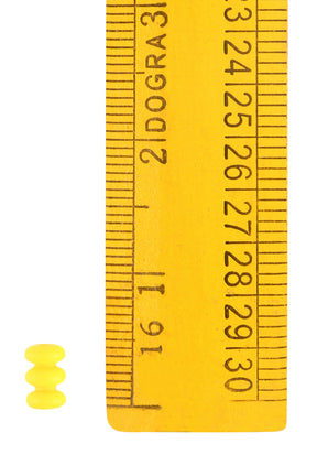 Gul glaspärla från Gotland visad tillsammans med mätstav för storleksreferens. Dokumentationsfoto av handgjord vikingatida pärl i translucent glas.