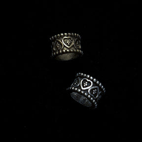 Multiple brass beard beads worn in long styled beard demonstrating practical application