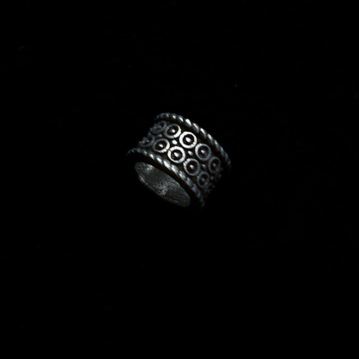 Birnir brass beard bead rotated to show full relief sun symbol pattern and hollow tube construction