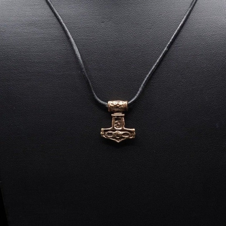 Bronze Torshammare Valhalla pendant on black cord, shown in neutral lighting emphasizing pendant form and texture