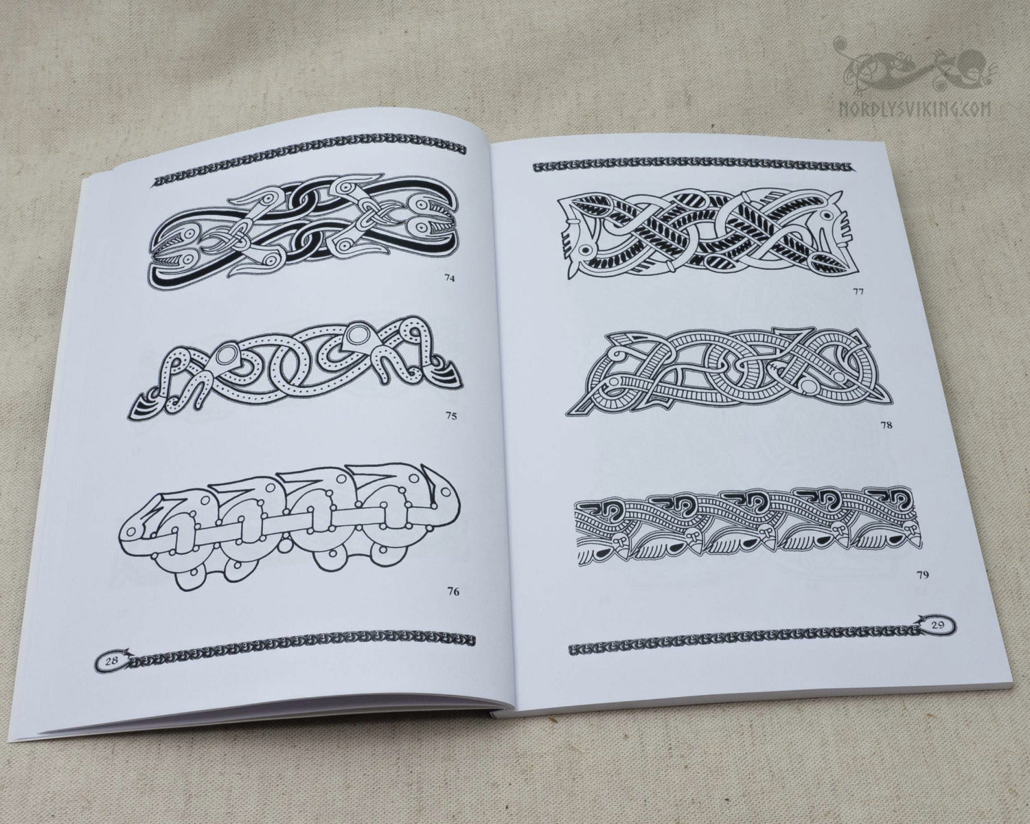 Book pages displaying Vendel-era ornamental border patterns with braided designs and geometric frames