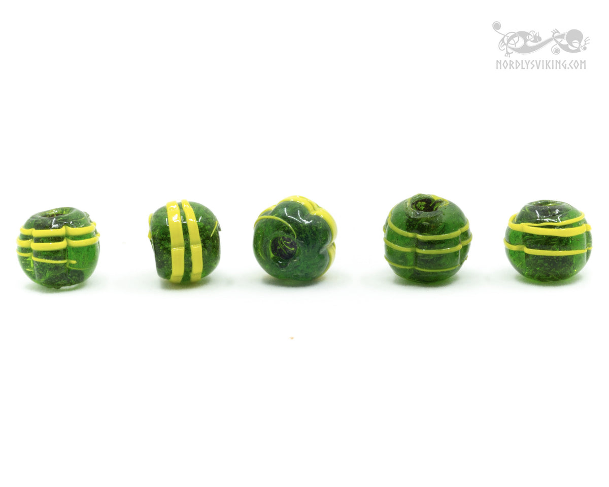 Mörkgrön melonformad glaspärla med gul spiral- och linjdekor. Fem rotationsvinklar av samma pärltyp på vit bakgrund, visar konsistens i vikingatida tillverkning.